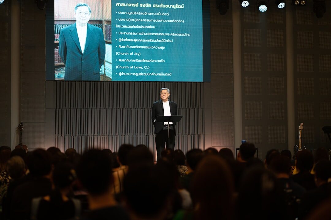 Speaker presenting on stage at a business event