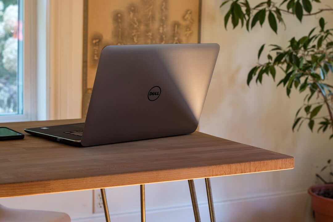 laptop on desk with notes